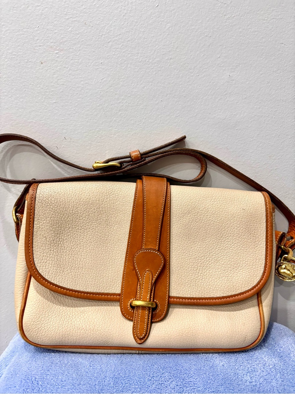 Dooney and Bourke all weather leather/solid brass vintage crossbody bag
